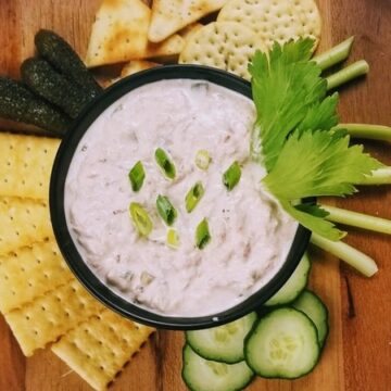 tuna dip in bowl served with crackers and veggies