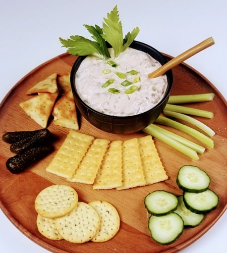 Bowl of Smoked Tuna Dip on a wooden tray with crackers and vegtables