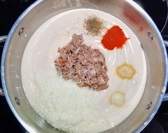 cheese sauce in a pot with tuna, parmesan and seasonings