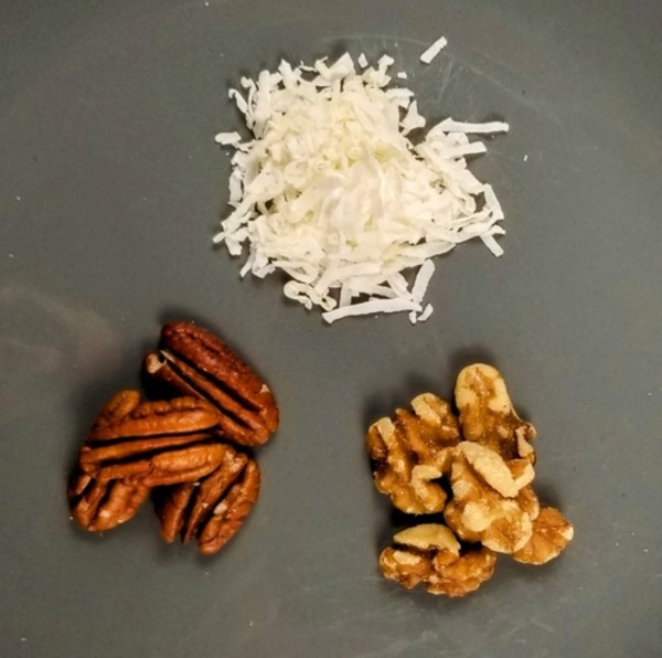 coconut, walnuts, pecans on a plate