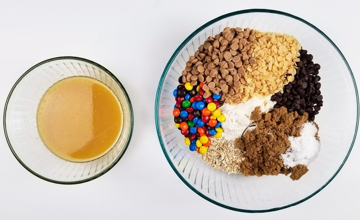 wet ingredients in a small bowl and dry ingredients in a big bowl set on a white counter