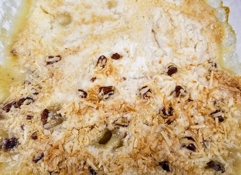 peach cobbler dump cake with white cake mix and baked with coconut and pecans