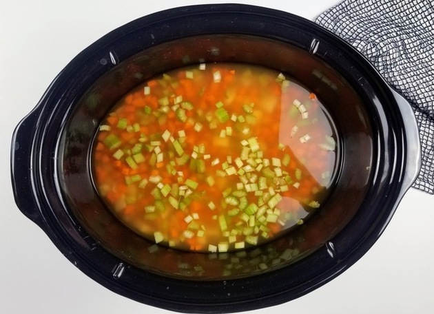 chicken broth with vegtables in a crockpot for cheeseburger soup recipe