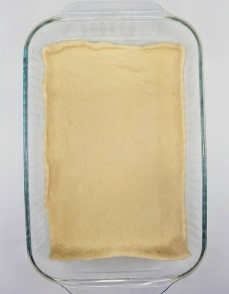 crescent roll dough covering bottom of cake pan