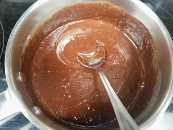 chocolate gnache frosting cooking in a pan