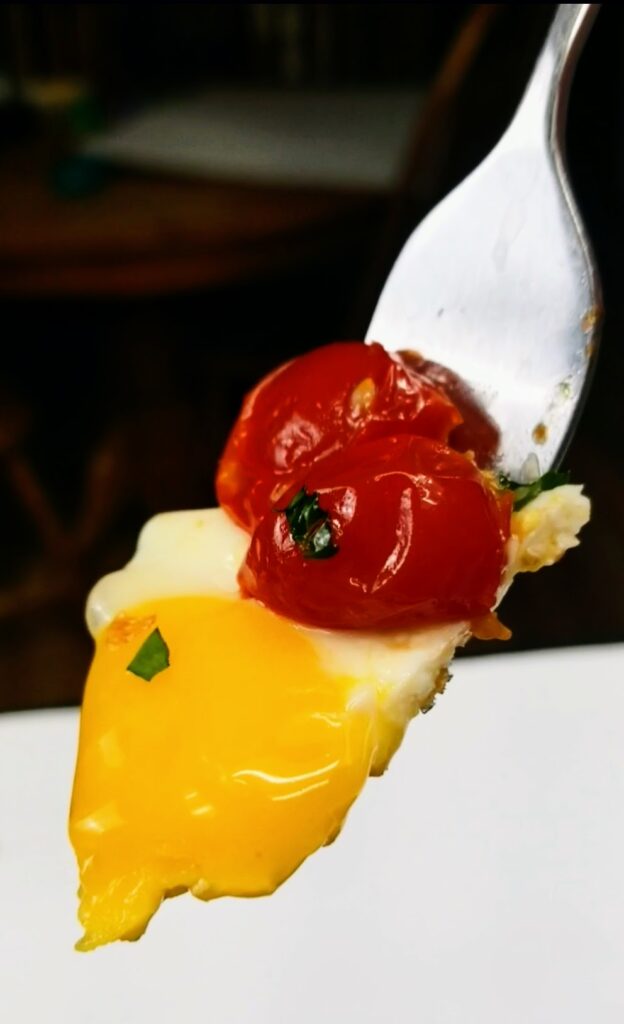 eggs and cherry tomatoes on a fork